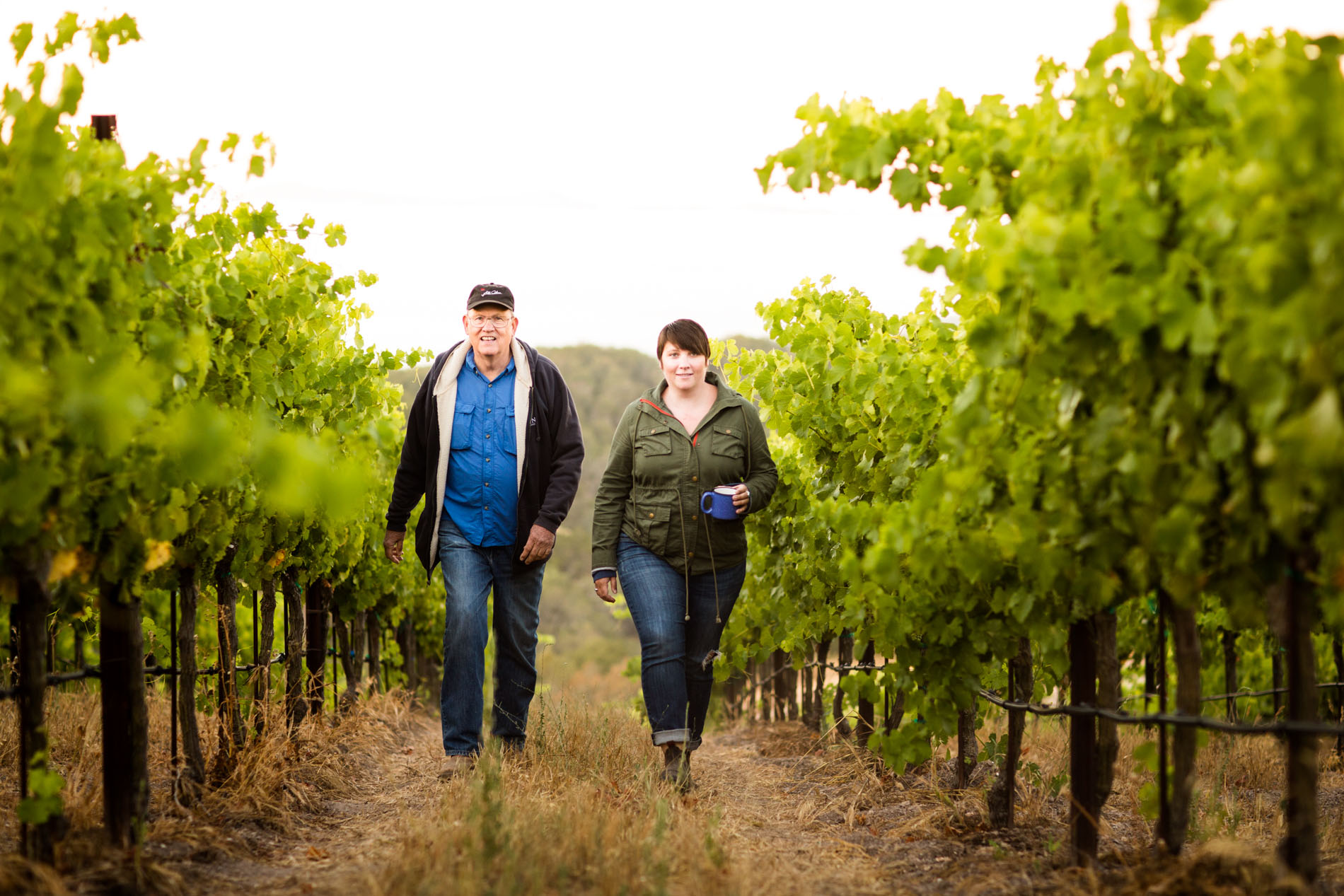 Man and woman walking through the vineyard